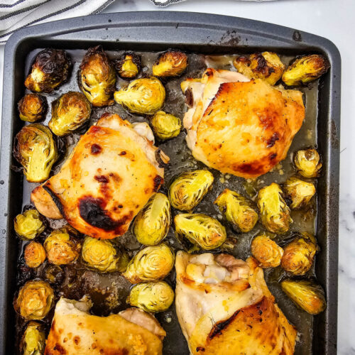 Honey mustard sheet pan chicken thighs with roasted brussels sprouts, golden and caramelized
