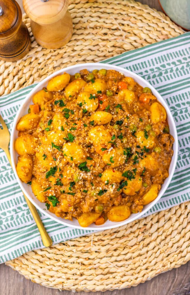 One pan gnocchi shepherd's pie with meat sauce and potato gnocchi garnished with fresh parsley