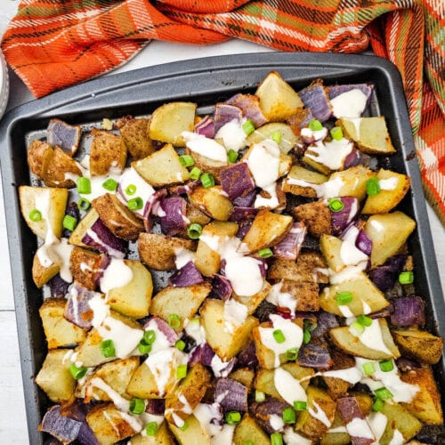 Sheet Pan Buffalo Chicken with roasted potatoes and beets topped with sour cream and green onions