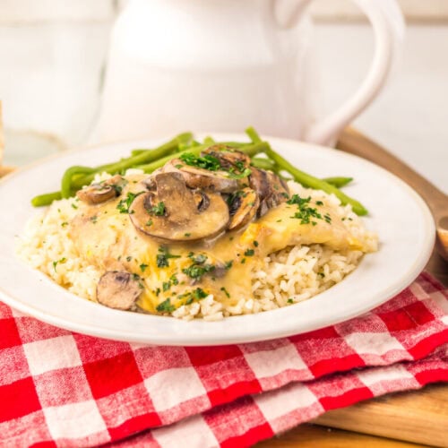 Slow cooker chicken and rice with mushrooms and green beans on white plate