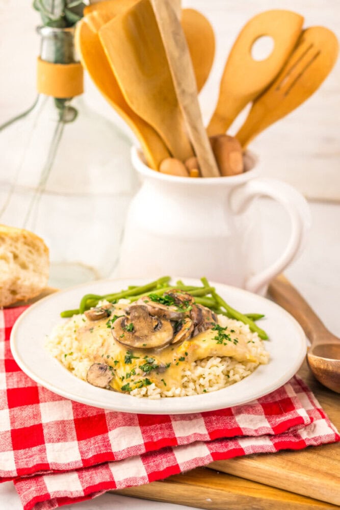 Slow cooker chicken and rice with mushrooms and green beans plated on white dish