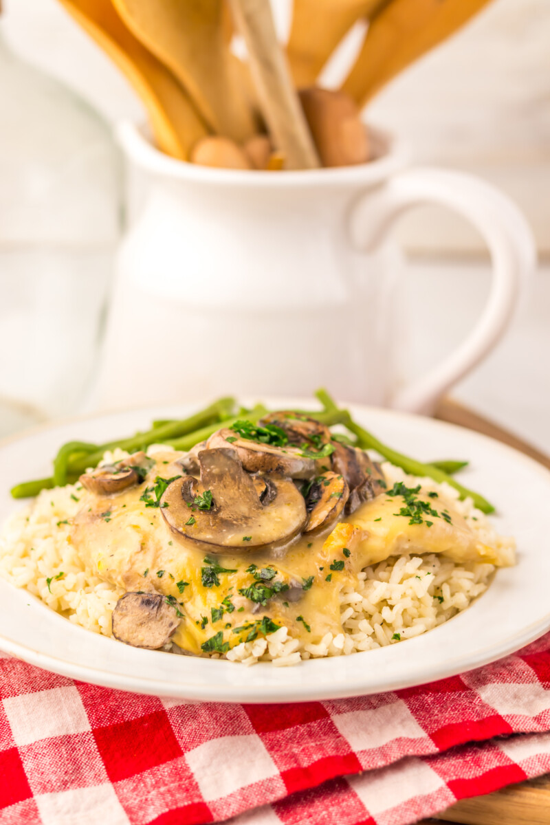 Slow cooker chicken and rice with mushrooms and green beans plated on white dish
