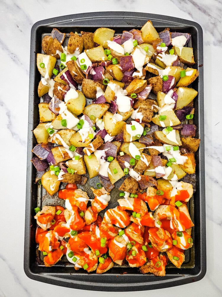 Sheet pan buffalo chicken with roasted potatoes, sausage, bell peppers, sour cream and scallions
