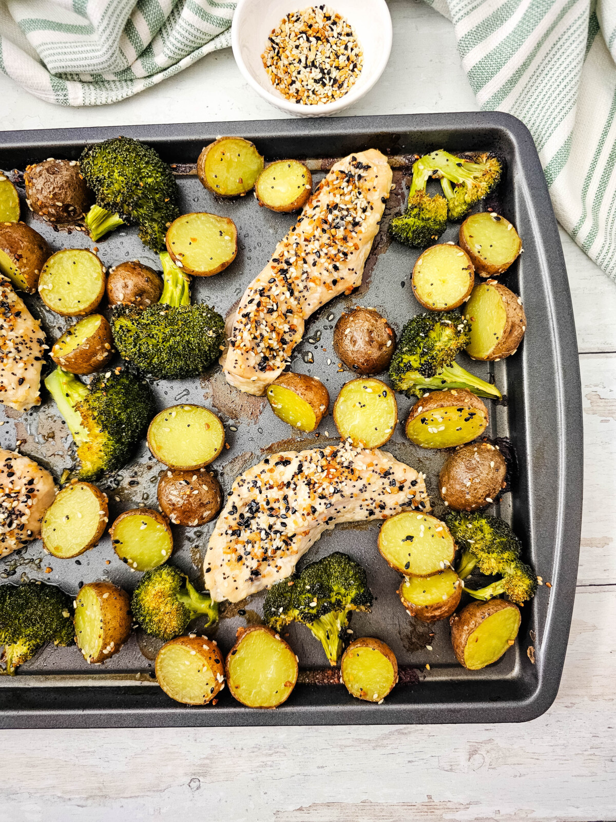 Sheet pan everything bagel chicken with roasted potatoes and broccoli overhead view