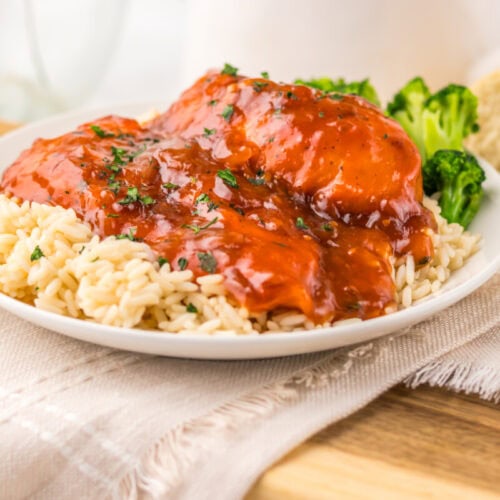 Slow cooker Catalina chicken with glossy red glaze served over pasta with broccoli