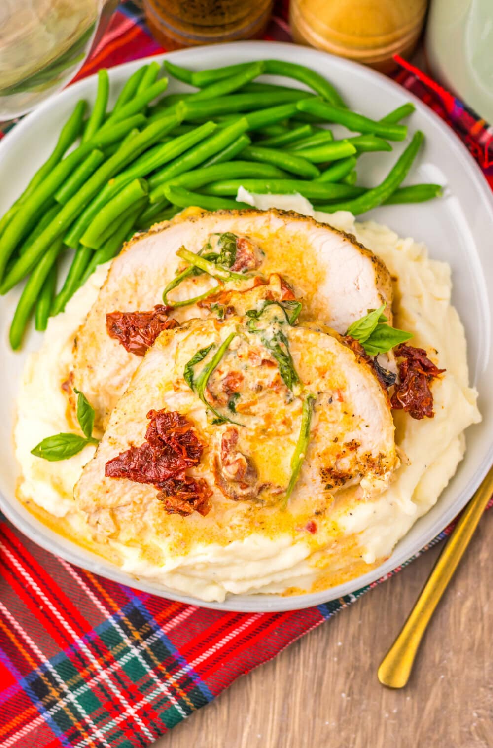 Slow cooker turkey breast with bacon and green onion garnish served with mashed potatoes and green beans