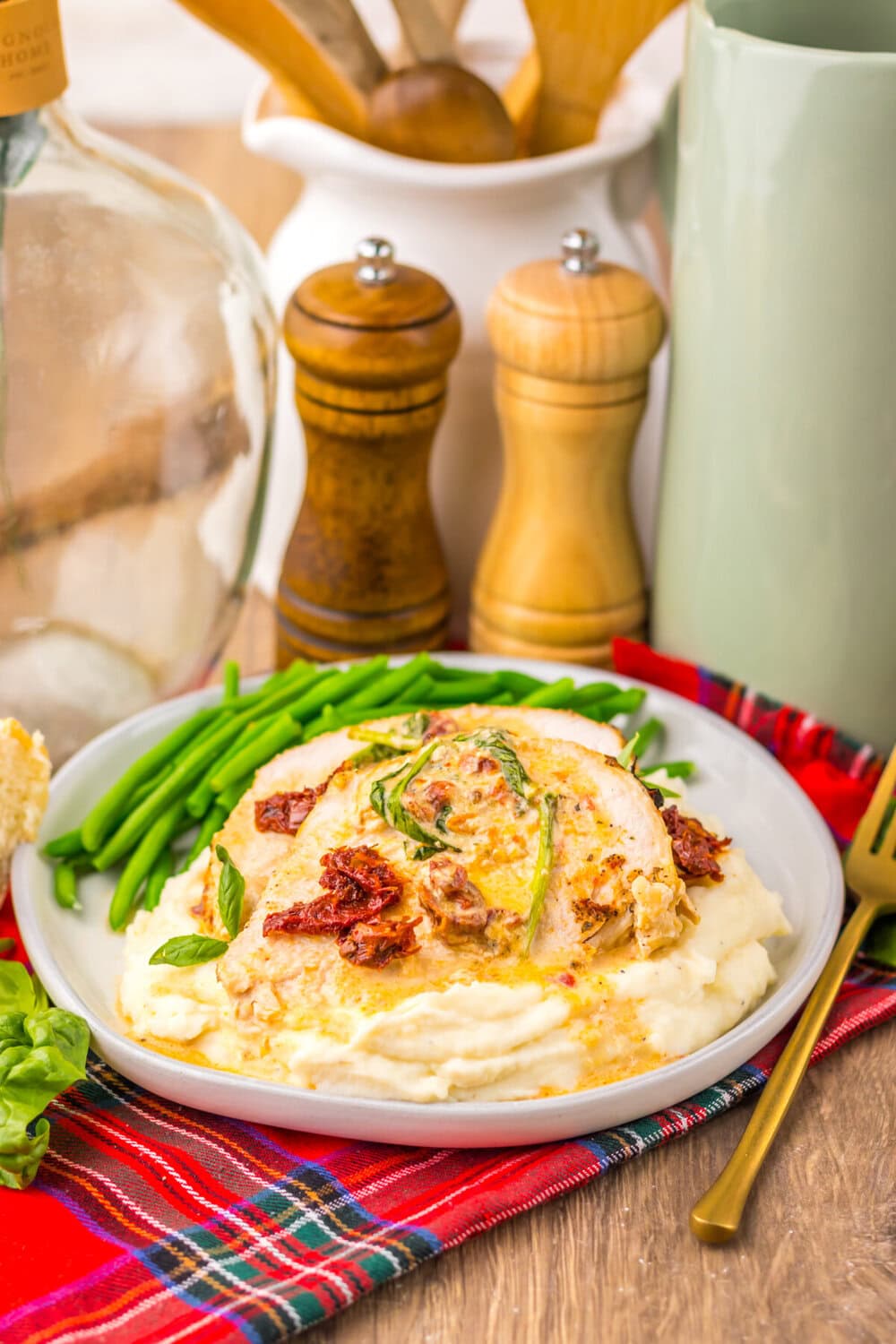 Slow cooker marry me turkey breast with cream sauce, bacon, and green beans plated on white dish