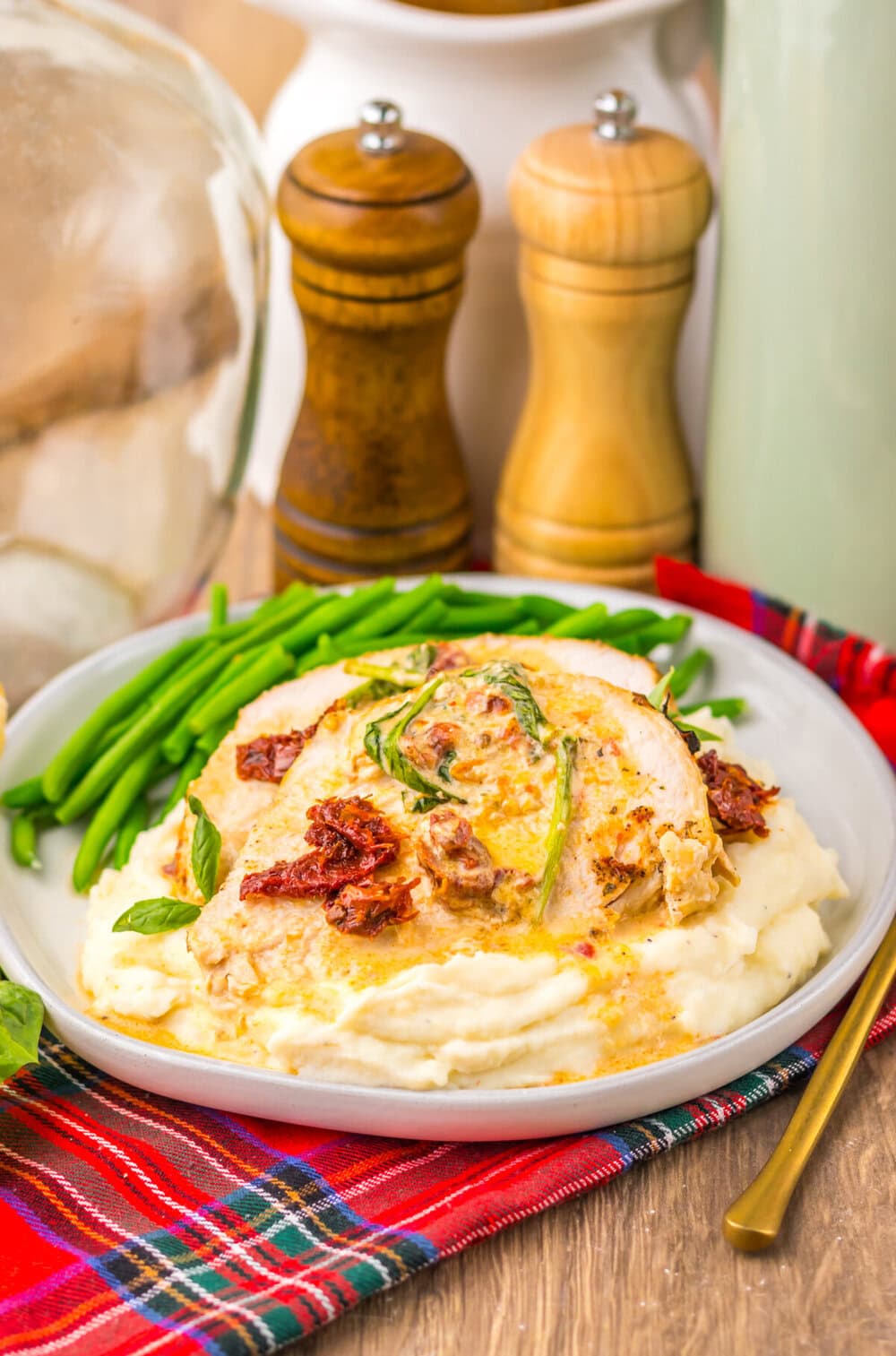 Slow cooker turkey breast topped with bacon and rosemary, served with green beans and mashed potatoes